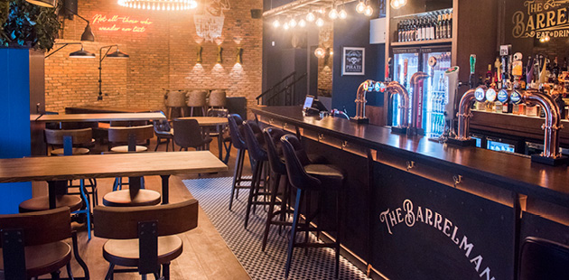 Inside a Scotland pub with neon lights and bare brick