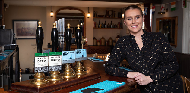 Pub manager woman at bar cask real ale